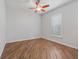 Light-filled bedroom with wood floors and a ceiling fan at 12198 Se 176Th Loop, Summerfield, FL 34491