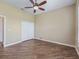 Bedroom showcasing wood floors, ceiling fan, and closet at 12198 Se 176Th Loop, Summerfield, FL 34491