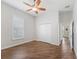 Spacious bedroom featuring wood floors, ceiling fan, and closet at 12198 Se 176Th Loop, Summerfield, FL 34491