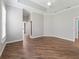 Unfurnished bedroom boasts tray ceiling, bright window, and wood flooring at 12198 Se 176Th Loop, Summerfield, FL 34491