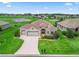 Well-maintained single-story home with a lush lawn, attached two-car garage, and manicured landscaping at 12198 Se 176Th Loop, Summerfield, FL 34491