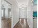 Bright foyer with wood-look floors, white trim, and view to the front door and a spacious room at 12198 Se 176Th Loop, Summerfield, FL 34491