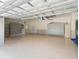 Spacious garage with epoxy floor, custom storage cabinets, insulated garage door, and high ceilings at 12198 Se 176Th Loop, Summerfield, FL 34491