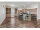 Open kitchen with kitchen island, stainless steel appliances, and custom cabinetry at 12198 Se 176Th Loop, Summerfield, FL 34491