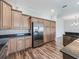 Gourmet kitchen with stainless steel refrigerator, granite countertops, and abundant cabinetry at 12198 Se 176Th Loop, Summerfield, FL 34491