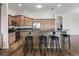 Kitchen island with granite countertops, dark wood accents, and barstool seating at 12198 Se 176Th Loop, Summerfield, FL 34491