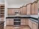 Kitchen featuring stainless appliances, granite countertops, and custom cabinets at 12198 Se 176Th Loop, Summerfield, FL 34491