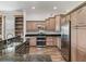 Kitchen with custom cabinets, stainless appliances, granite counters, and breakfast bar at 12198 Se 176Th Loop, Summerfield, FL 34491