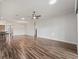 Spacious open-concept living area with wood-look tile flooring and recessed lighting at 12198 Se 176Th Loop, Summerfield, FL 34491