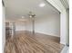 Open-concept living area with wood-look tile flooring and access to the patio at 12198 Se 176Th Loop, Summerfield, FL 34491