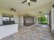 Spacious outdoor patio features a built-in grill, mini fridge, brick flooring, and fire pit at 12198 Se 176Th Loop, Summerfield, FL 34491