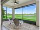 Screened-in lanai with a view of the golf course and outdoor seating at 12198 Se 176Th Loop, Summerfield, FL 34491
