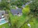 An aerial view of a house featuring a dark roof, big backyard, and outdoor seating area near pool at 1237 Mercedes Pl, Orlando, FL 32804
