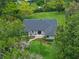 Aerial view of house with manicured landscaping and inviting outdoor seating area near green lawn at 1237 Mercedes Pl, Orlando, FL 32804
