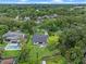 An aerial view of a house with a large backyard, a pool, and an outdoor seating area surrounded by trees at 1237 Mercedes Pl, Orlando, FL 32804