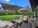 Backyard features a patio with outdoor furniture, lush green lawn, and mature trees at 1237 Mercedes Pl, Orlando, FL 32804