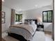 Bright bedroom featuring two windows, stylish decor, and plush bedding at 1237 Mercedes Pl, Orlando, FL 32804