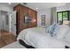 Well-appointed bedroom featuring wood paneling, modern TV, and comfortable decor at 1237 Mercedes Pl, Orlando, FL 32804