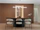 Modern dining room with wine storage, contemporary lighting, and seating for six at 1237 Mercedes Pl, Orlando, FL 32804