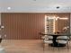 Elegant dining room with custom wall paneling, wine storage, and modern lighting at 1237 Mercedes Pl, Orlando, FL 32804