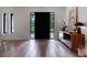 Modern entryway with a black front door, light wood floors, and a stylish console table at 1237 Mercedes Pl, Orlando, FL 32804