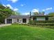 Contemporary home with a lush green lawn, a paved driveway, and modern architectural details at 1237 Mercedes Pl, Orlando, FL 32804