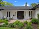 Home showcasing a modern exterior, well-manicured landscaping, and stylish seating area at 1237 Mercedes Pl, Orlando, FL 32804