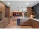 Open concept kitchen with wood cabinetry and integrated beverage cooler at 1237 Mercedes Pl, Orlando, FL 32804