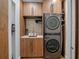 Laundry room showcases washer, dryer, storage cabinets, sink, and modern finishes at 1237 Mercedes Pl, Orlando, FL 32804