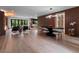 Open-concept living room with sleek furniture, dining area and adjacent bar at 1237 Mercedes Pl, Orlando, FL 32804