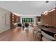 Open-concept living room featuring hardwood floors, modern furniture, and access to the backyard at 1237 Mercedes Pl, Orlando, FL 32804