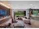 Open-concept living room with a fireplace, sleek furniture, and a view of the backyard and modern kitchen at 1237 Mercedes Pl, Orlando, FL 32804