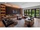 Modern living room with a fireplace, built-in shelving, sleek furniture, and a view of the backyard at 1237 Mercedes Pl, Orlando, FL 32804