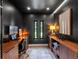 Home office boasts black walls, custom wood cabinetry, recessed lighting, and natural light at 1237 Mercedes Pl, Orlando, FL 32804