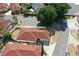 Aerial view of home featuring mature landscaping, a red roof, and a private driveway at 1325 Balboa Ct, The Villages, FL 32159