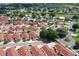 Expansive aerial view of the neighborhood showcasing homes with red roofs and mature trees at 1325 Balboa Ct, The Villages, FL 32159