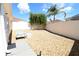 Serene backyard retreat with gravel landscaping, seating area, palm tree, and mature trees at 1325 Balboa Ct, The Villages, FL 32159