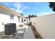Private backyard featuring a gravel area, seating, lush plantings, and an air conditioning unit at 1325 Balboa Ct, The Villages, FL 32159