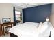 Comfortable bedroom features a bed, ceiling fan, and a natural light streaming through the window at 1325 Balboa Ct, The Villages, FL 32159