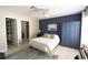 Comfortable bedroom featuring a painted accent wall, tiled floor, and en-suite bathroom access at 1325 Balboa Ct, The Villages, FL 32159