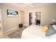 Bright bedroom featuring a bed, television, tiled floors, and an en-suite bathroom at 1325 Balboa Ct, The Villages, FL 32159