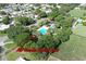 Aerial view of the Rio Grande Gathering Pool surrounded by trees, with the neighborhood in the background at 1325 Balboa Ct, The Villages, FL 32159