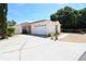 Charming single-story home with a well-maintained lawn, white garage door, and a spacious driveway at 1325 Balboa Ct, The Villages, FL 32159