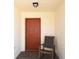 Cozy entryway featuring a brick floor, a wooden rocking chair, and a painted front door at 1325 Balboa Ct, The Villages, FL 32159