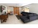 Comfortable living room with a large sectional couch, sliding barn doors, and a flat screen television at 1325 Balboa Ct, The Villages, FL 32159