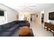 Bright living room with tile floors, ceiling fan, a comfortable sectional couch and view to dining area at 1325 Balboa Ct, The Villages, FL 32159