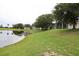 Beautiful backyard with a pond view and a grassy lawn for outdoor activities and relaxation at 1355 Misty Glen Ln, Clermont, FL 34711