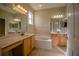 Well-lit bathroom featuring a soaking tub, double sinks, and a large mirror at 1355 Misty Glen Ln, Clermont, FL 34711