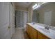 Well-lit bathroom with double sinks, shower, and closet at 1355 Misty Glen Ln, Clermont, FL 34711