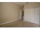Neutral bedroom featuring an entry door and a closet at 1355 Misty Glen Ln, Clermont, FL 34711
